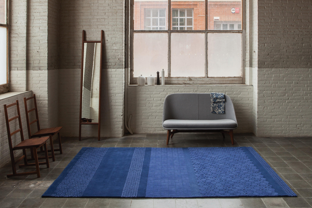 A rectangular rug accenting an open living space.