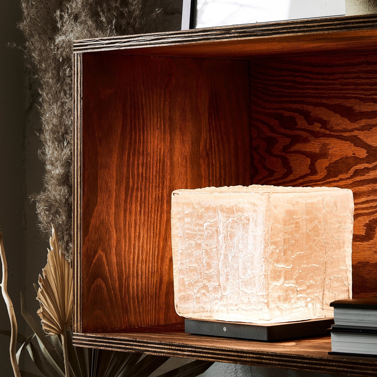 Ice cube-shaped table lamp inside wooden shelving unit