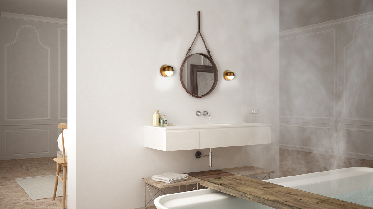 A large bathroom, with mirror and flanking wall sconces.