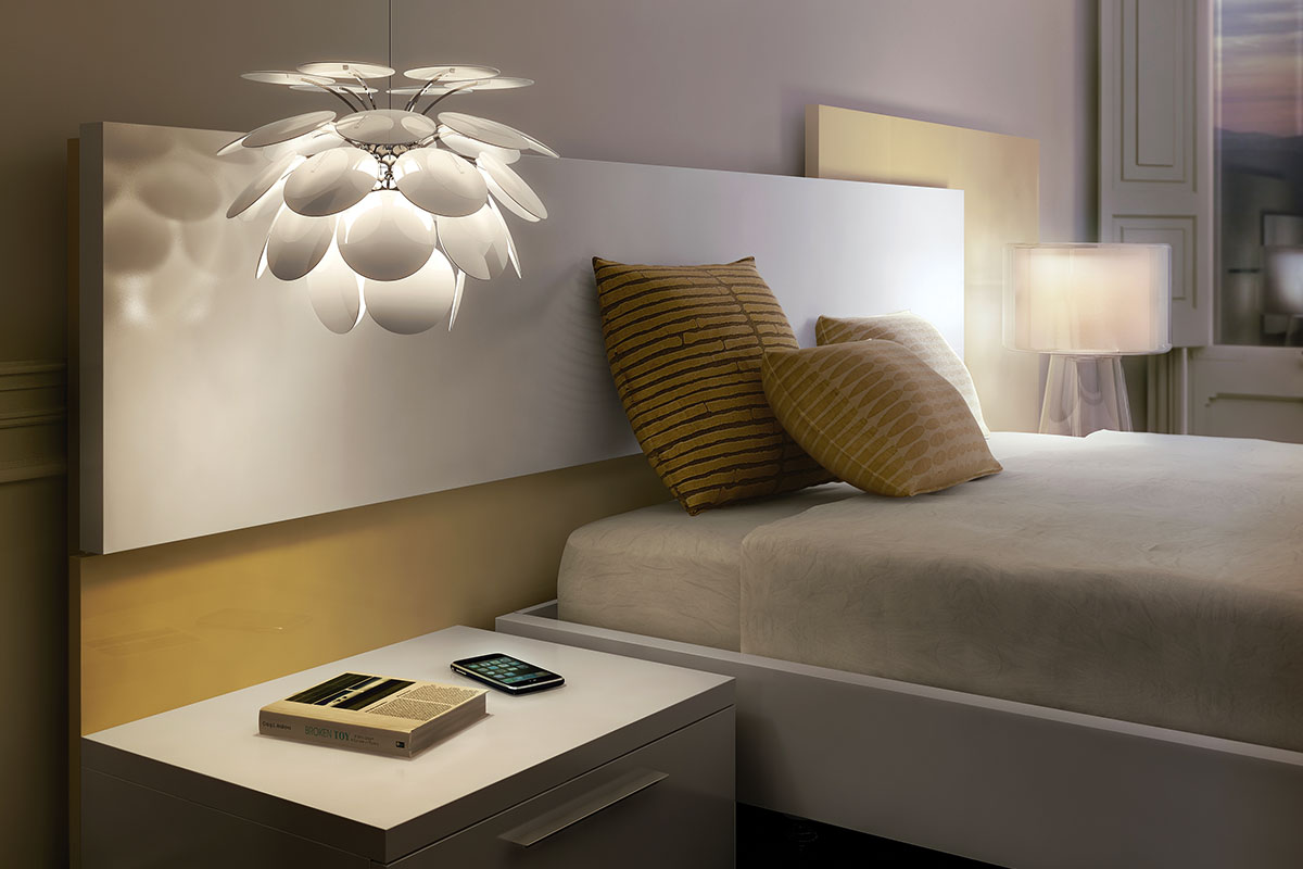 Discoco Pendant for Marset hanging over bedside table.
