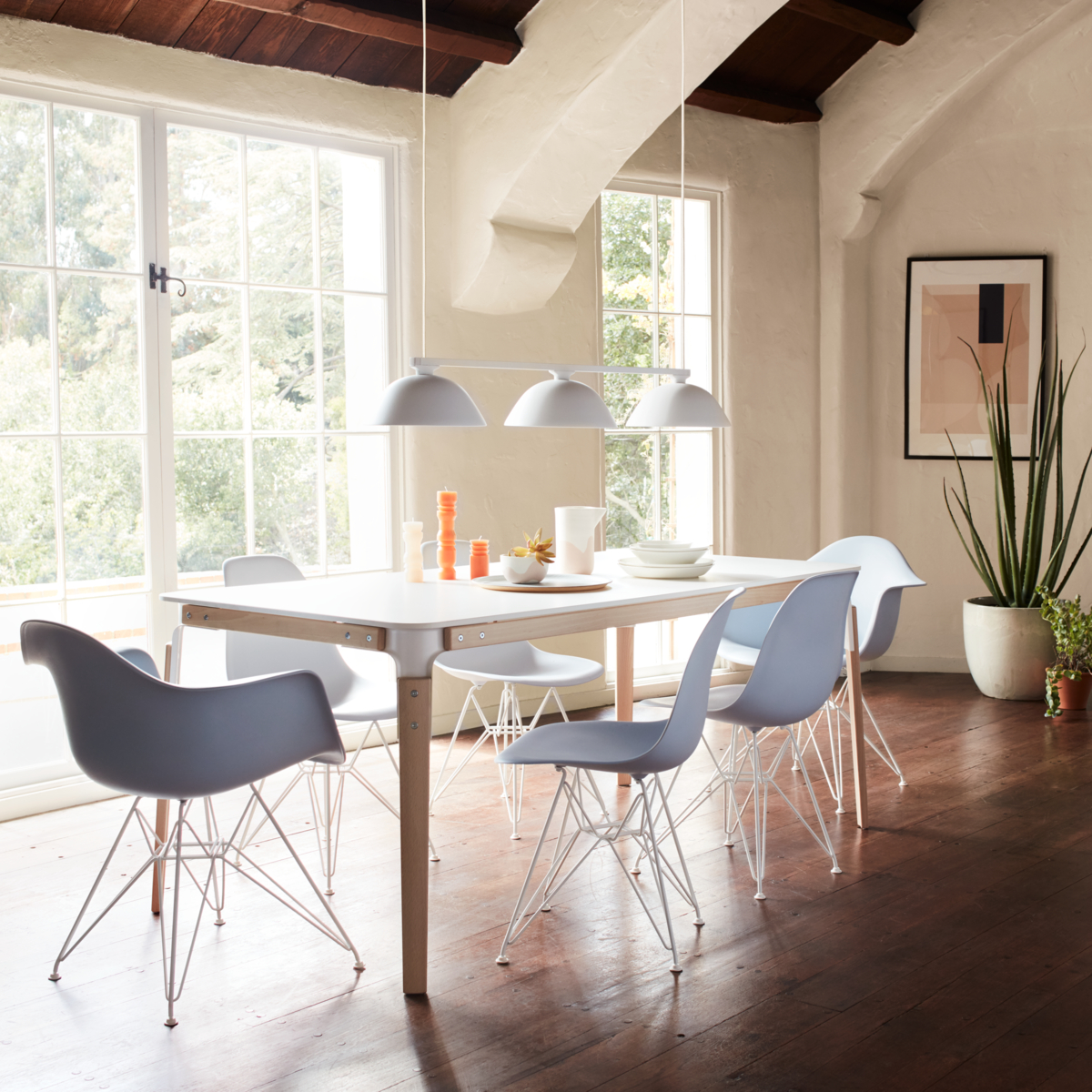 Modern dining set with pendant lighting in open dining area