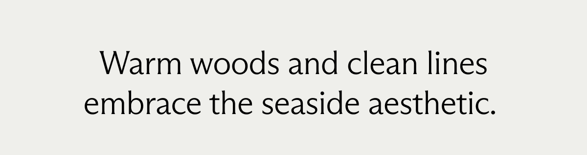 Warm woods and clean lines embrace the seaside aesthetic.