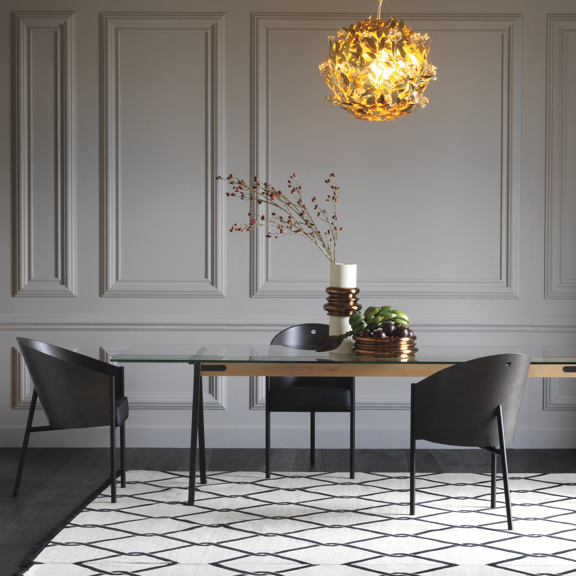 A sophisticated decor with a lengthy glass table and Costes Armchairs by Philippe Starck
