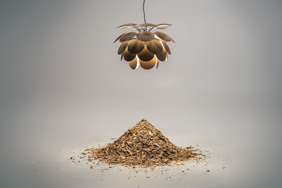 Studio picture of wood-leaved pendant light with wood chippings below in artful mountain