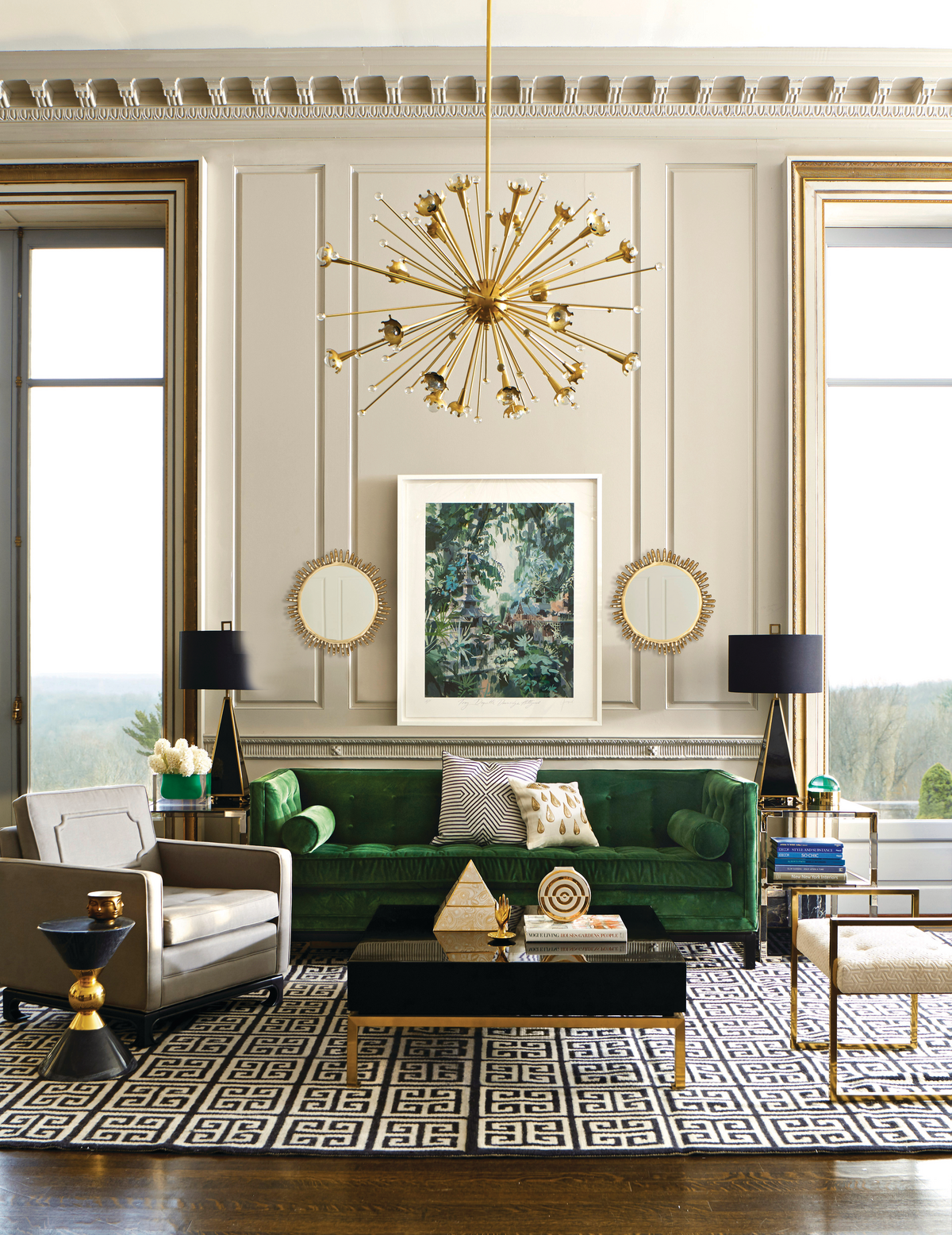 Golden sputnik chandelier in modern living room with gold accents and green velvet sofa