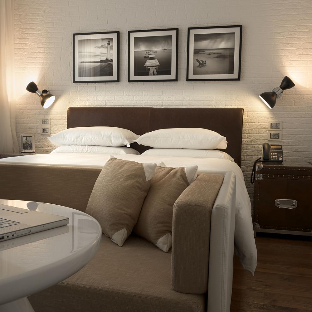 Cozy bedroom with wall sconce lighting.