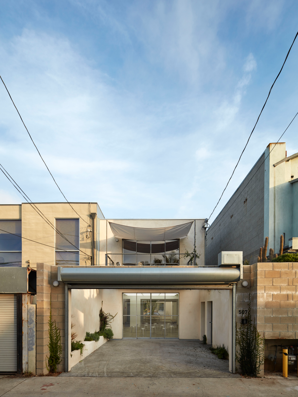 The exterior of a beige building with a blue sky above