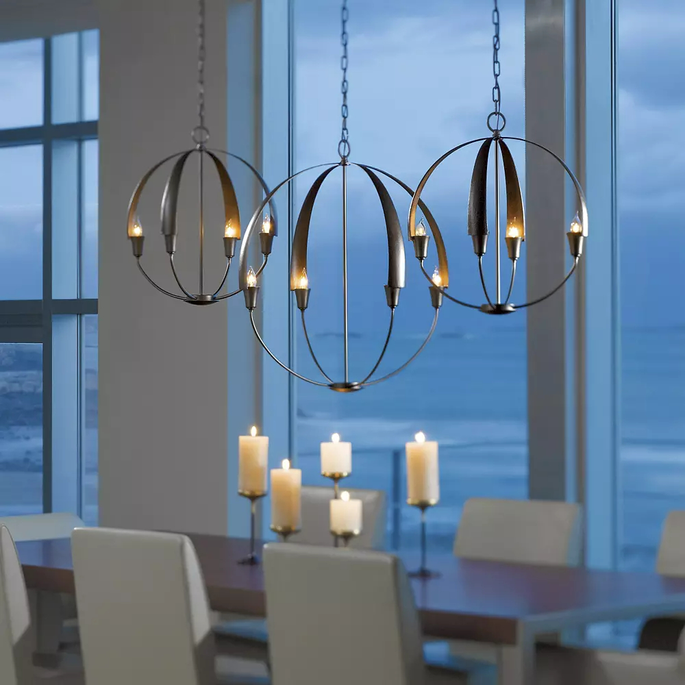 Open, candelabra-style chandeliers warmly lighting a space.