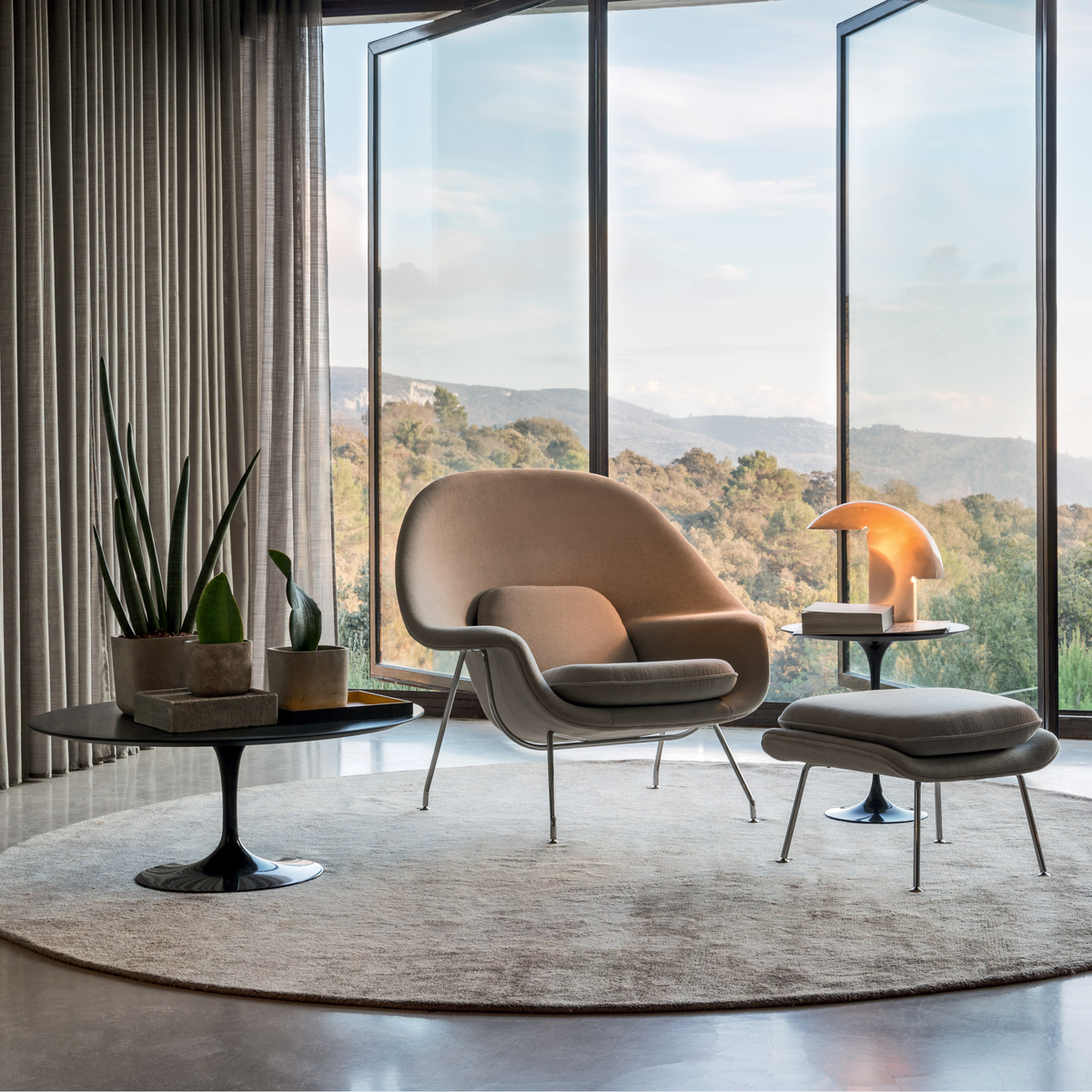 Eero Saarninen furniture in front of landscape view floor to ceiling window