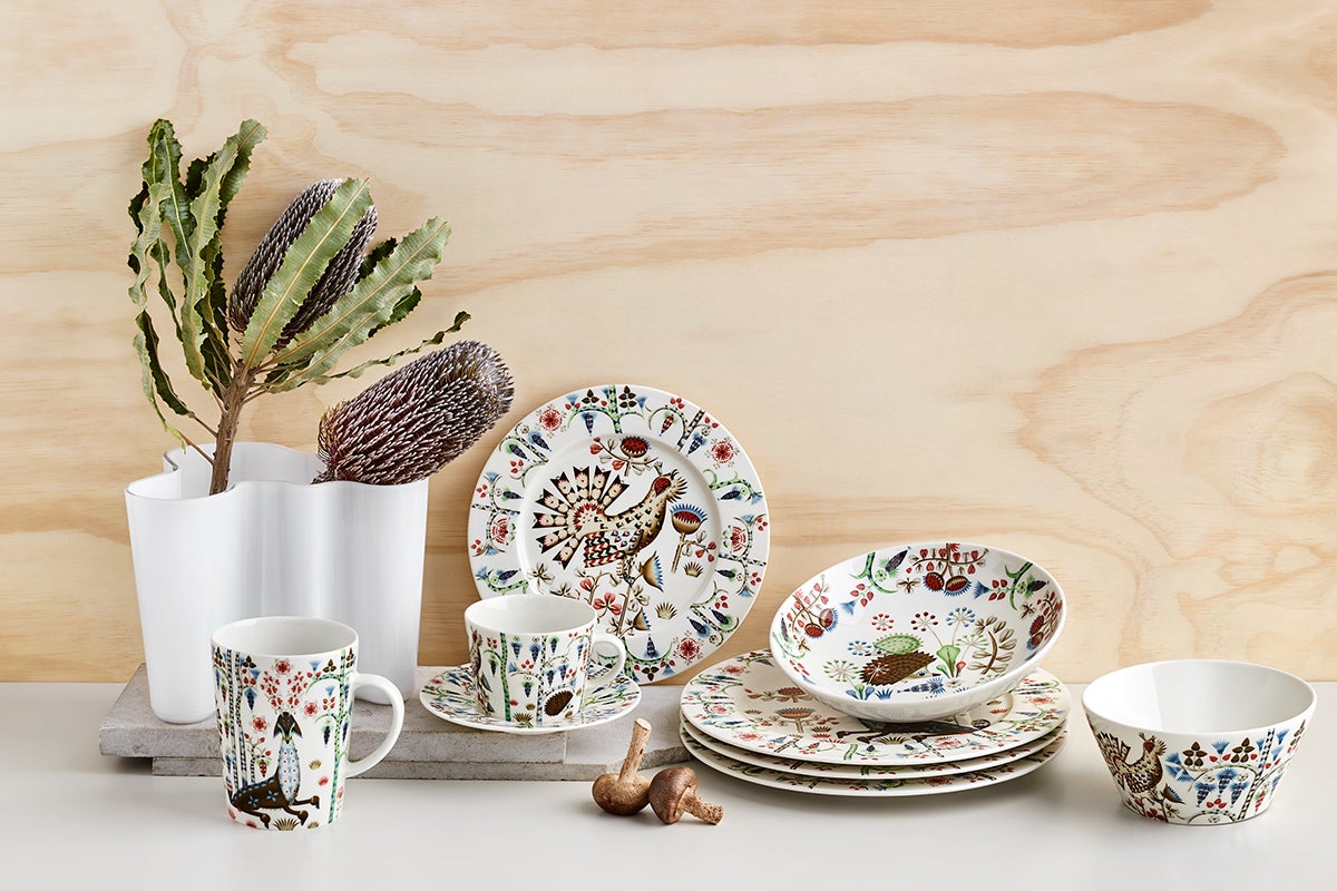 Folklore images on white dishware against natural wood backdrop