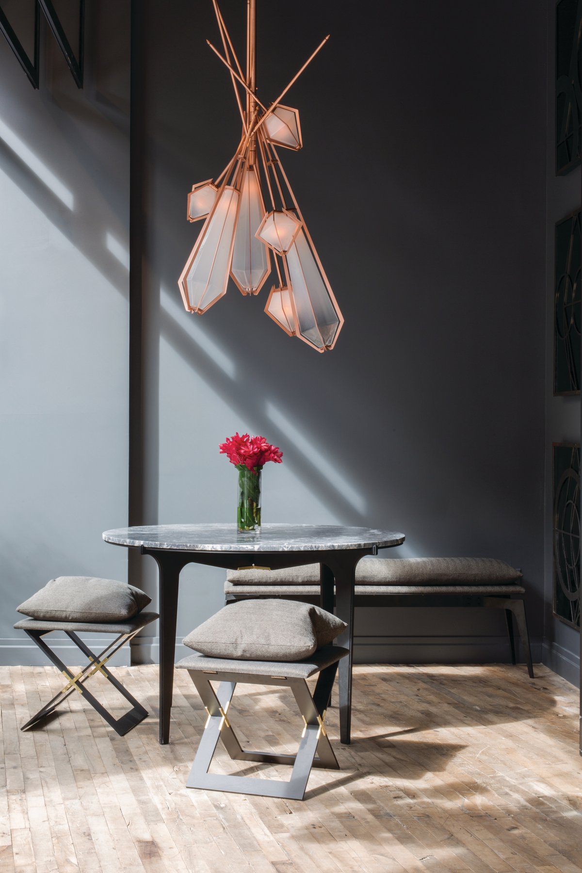 Quartz-shaped pendant over marble table with flower centerpiece