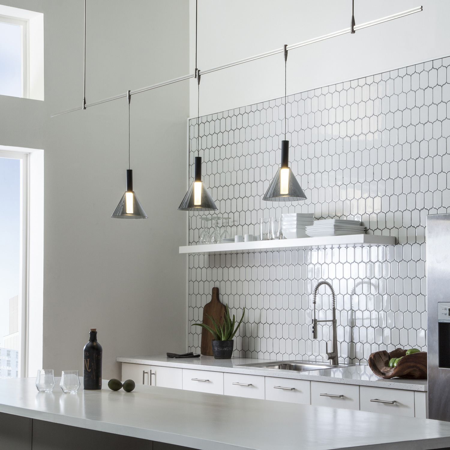 Mezz Mini Pendants suspended over a kitchen island.