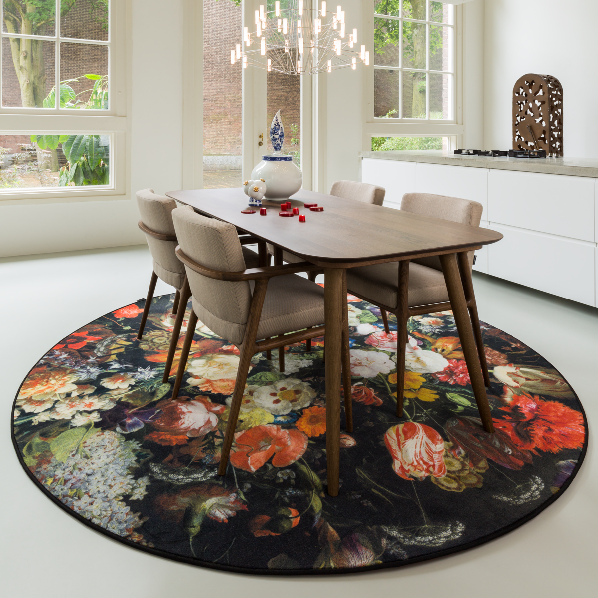 Picturesque circular floral rug in dining room with chandelier
