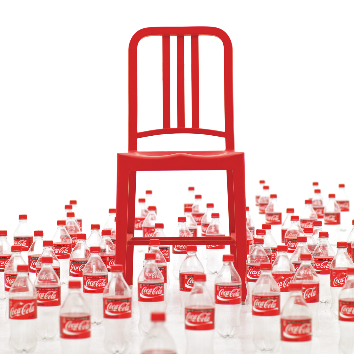 Navy Chair surrounded by empty Coca-Cola bottles.