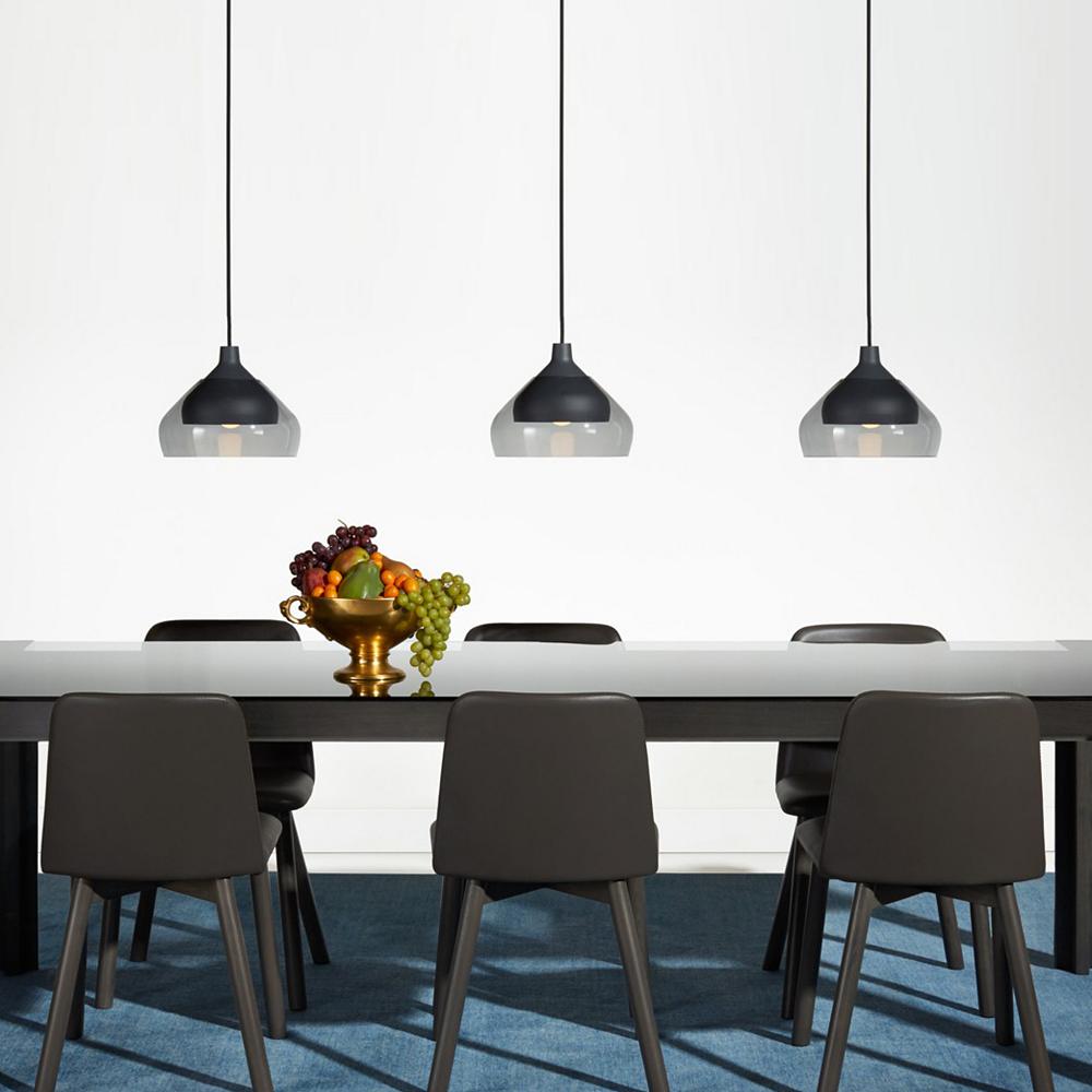 A set of pendants evenly spaced with bowl of fruit.