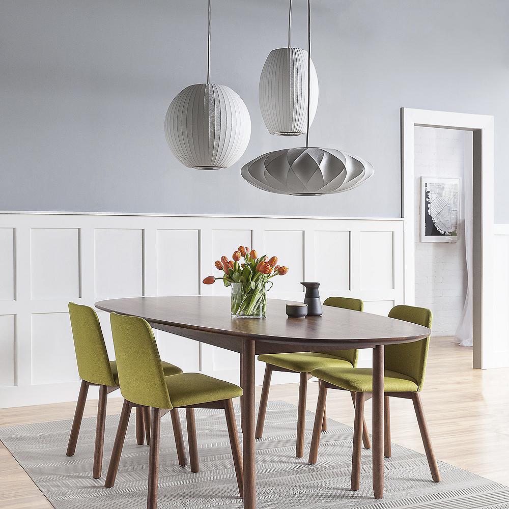 Shapely pieces stand out over a modern dining space.