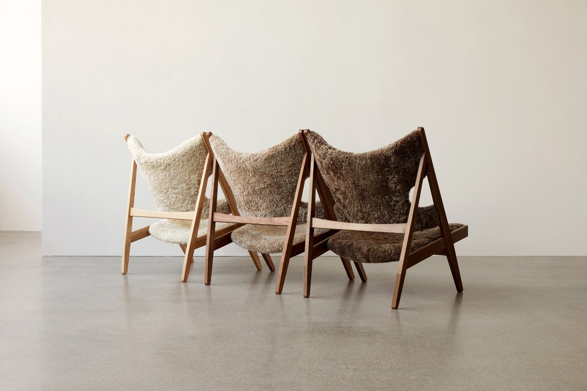 Three sheepskin chairs in neutral, open room