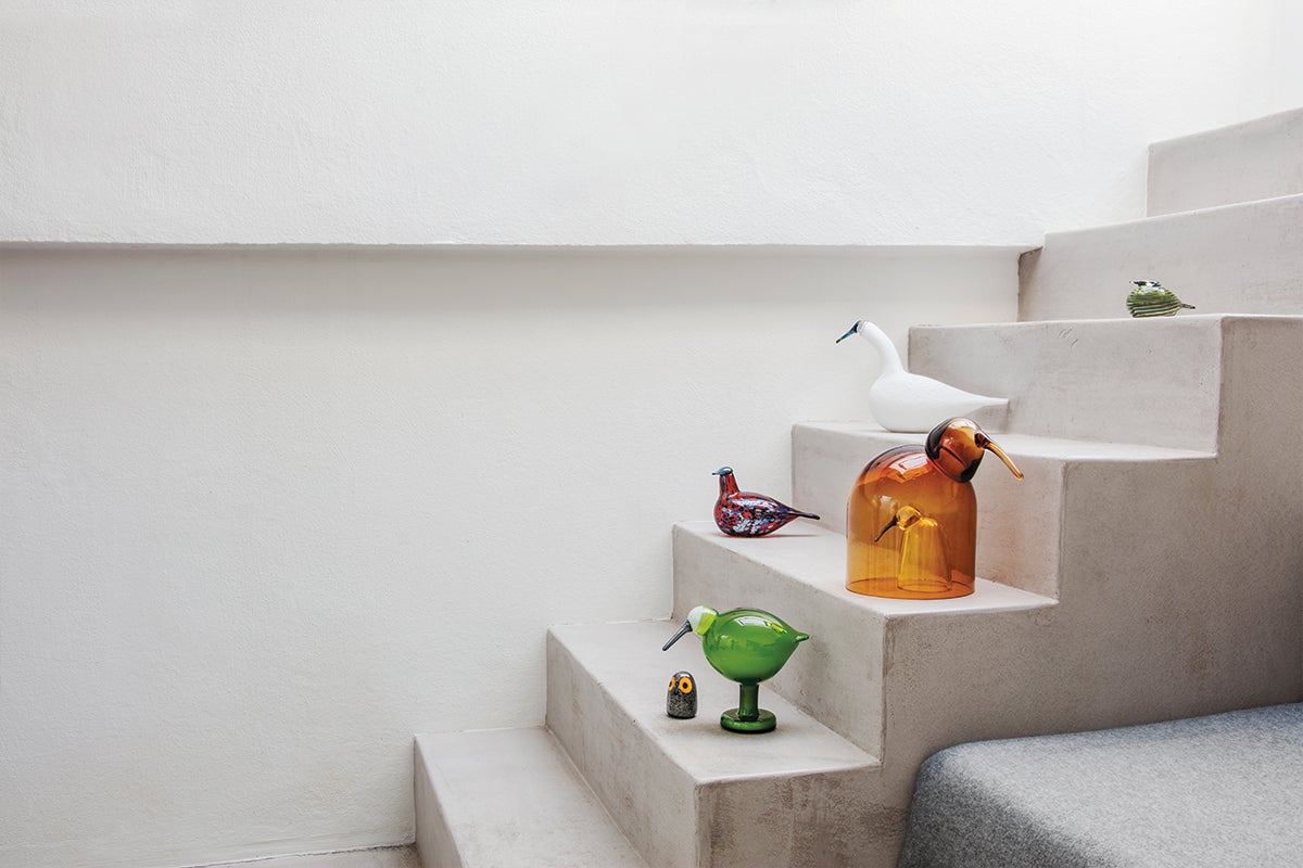 Bird-shaped littala glassware on concrete staircase