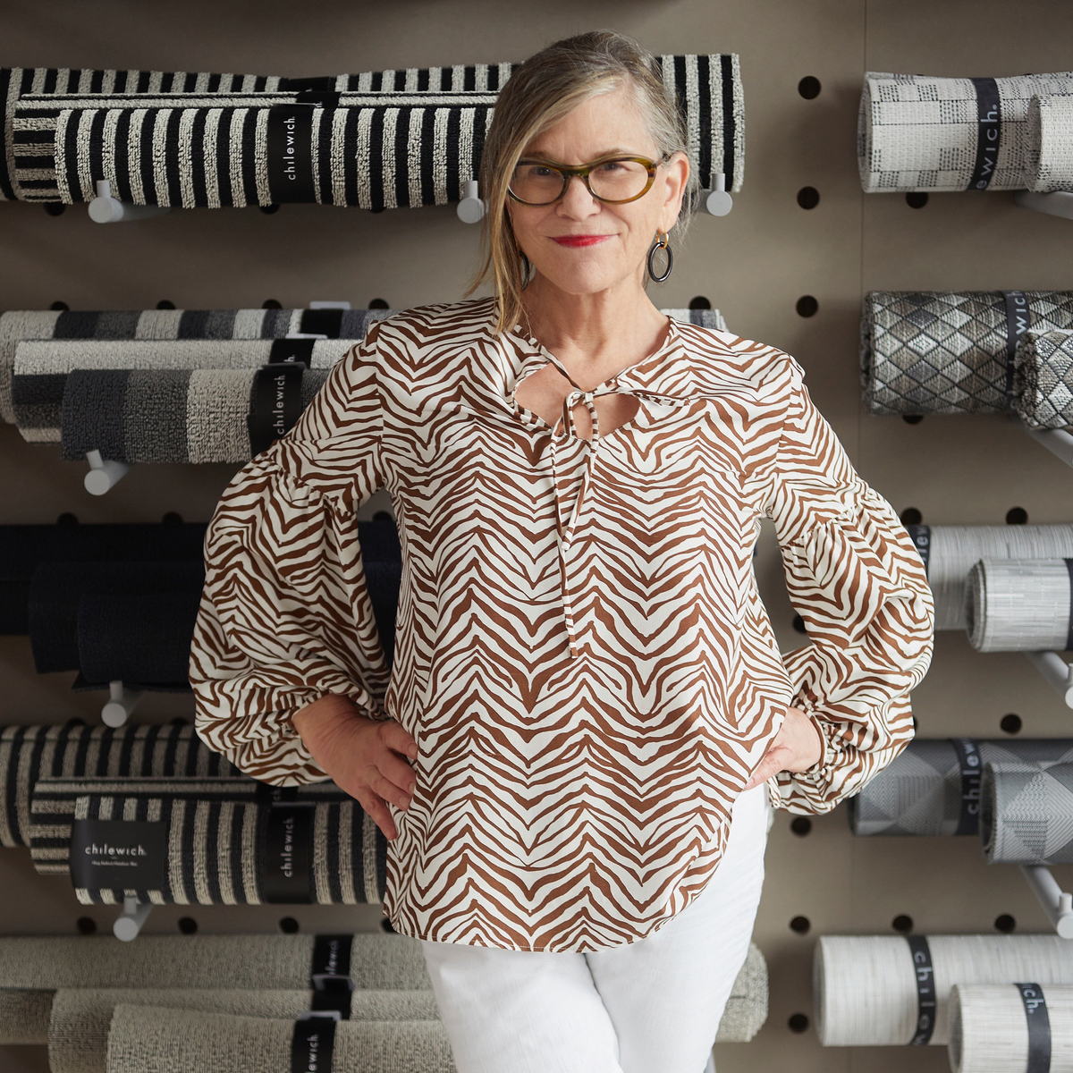 Sandy Chilewich poses in front of her rugs.