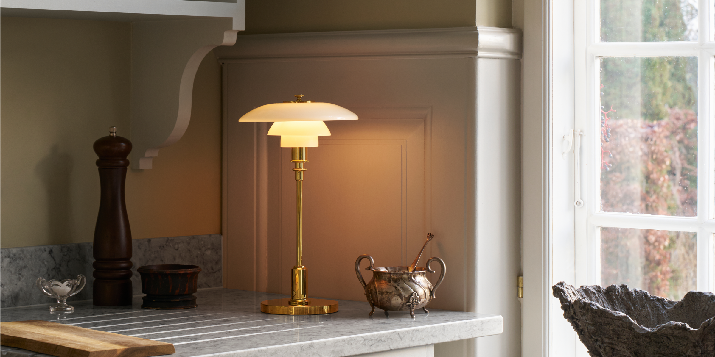 Cordless Louis Poulsen table tamp on a marble kitchen counter. 