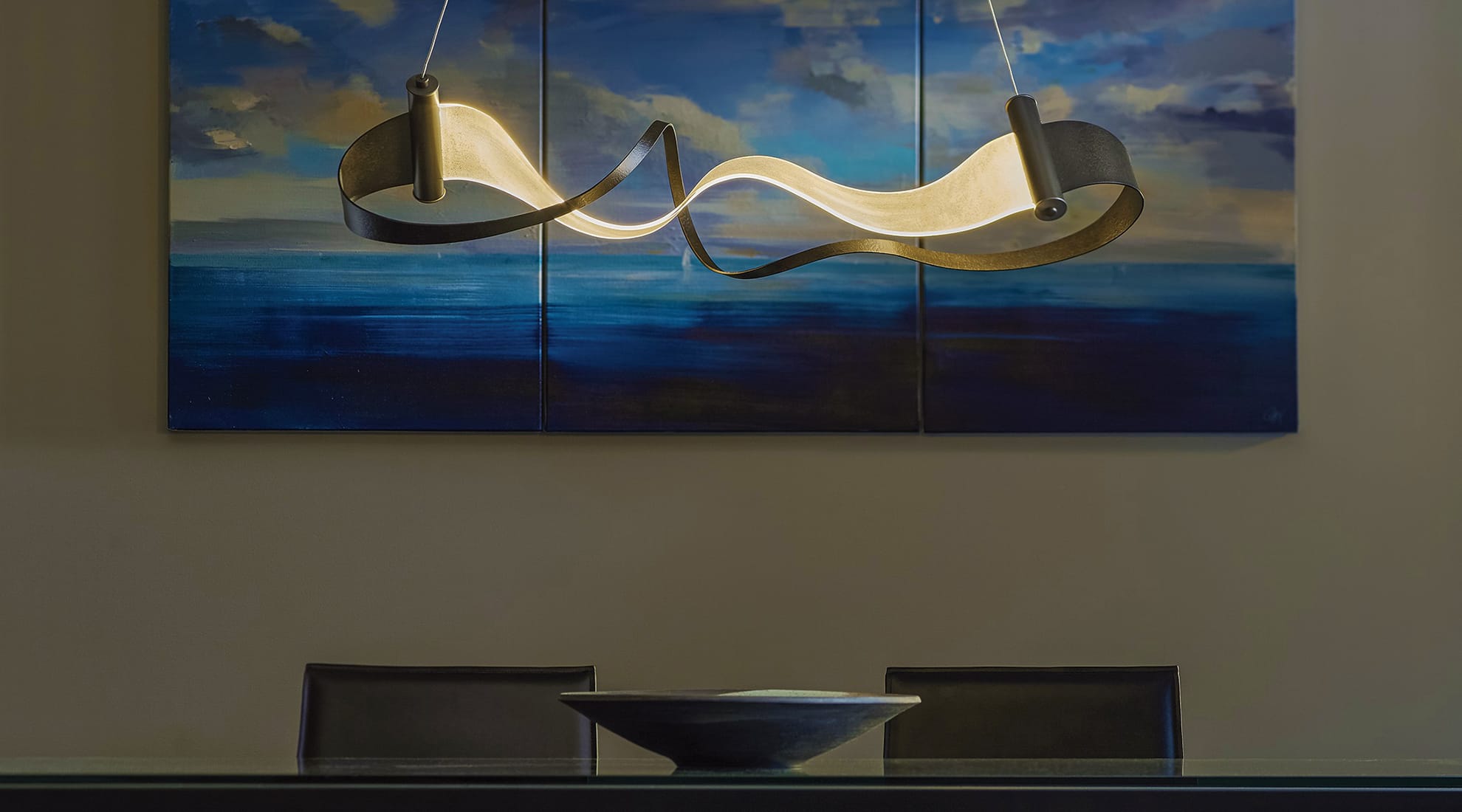 Zephyr LED Linear Suspension above a dining table.