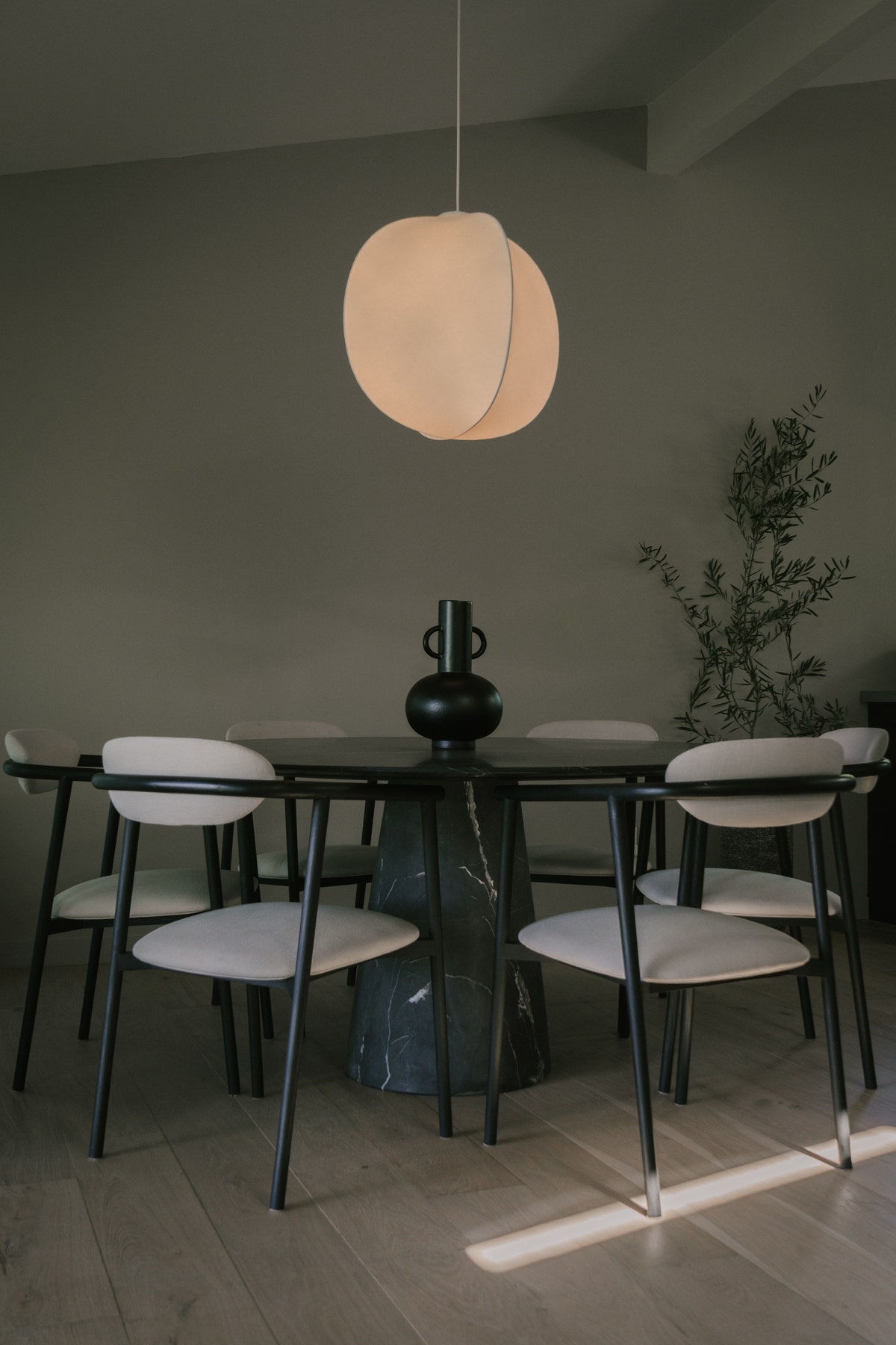Glowing light above black dining table scene