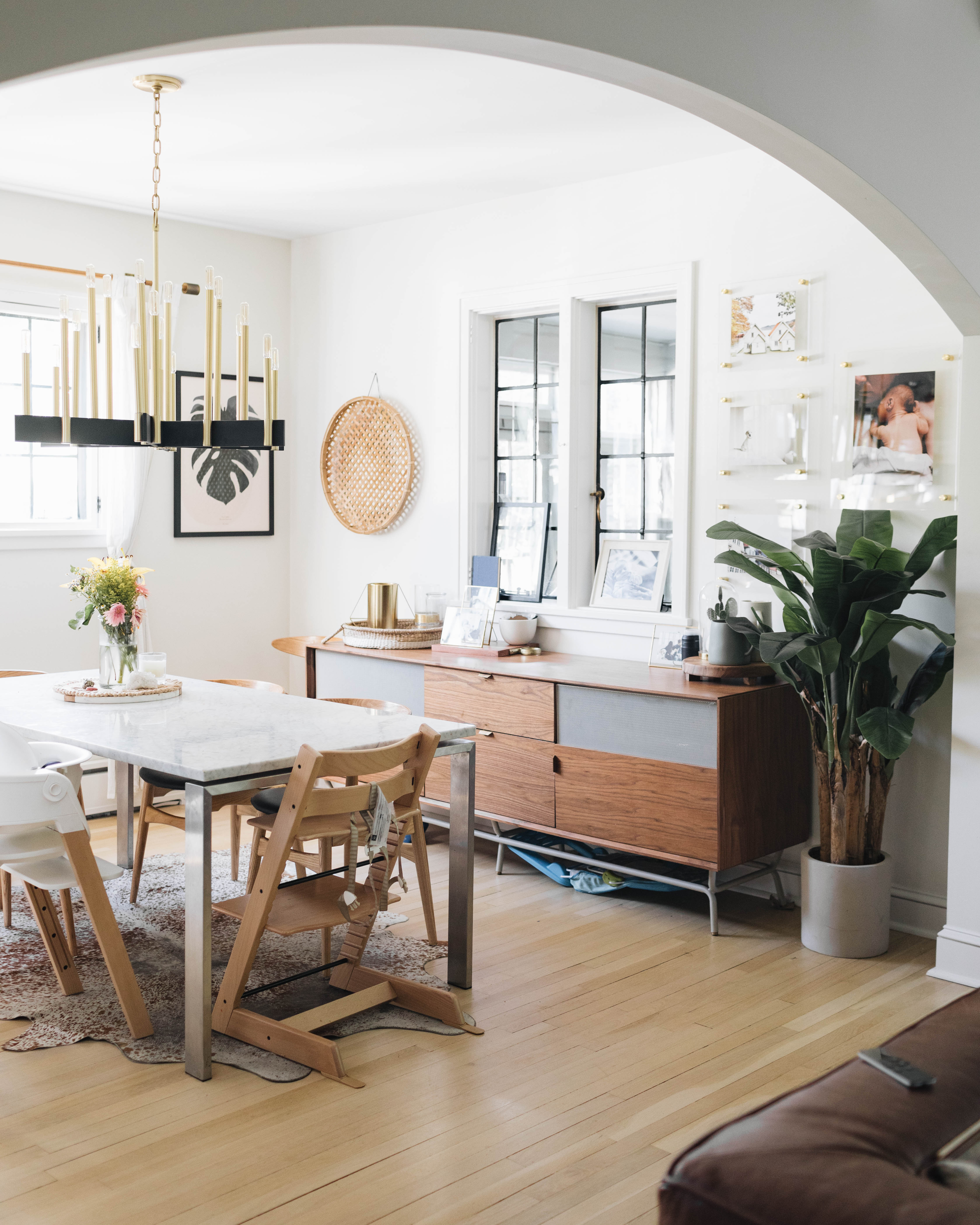 A cozy chandelier and dining space with candelabra bulbs.