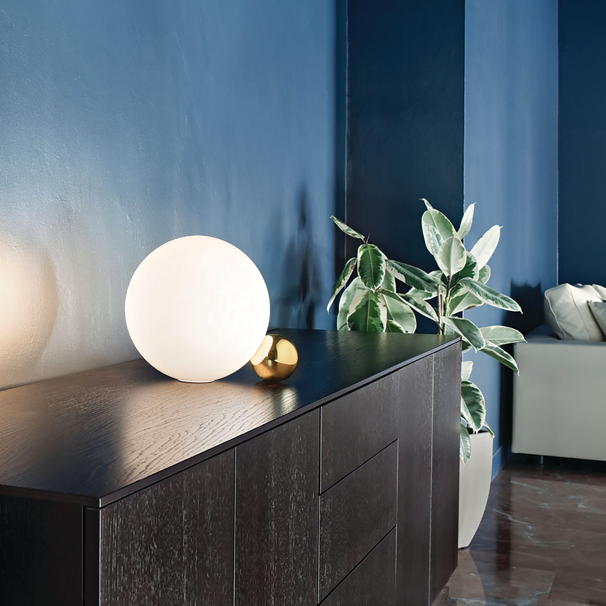 A warm, glowing table lamp accents the space.