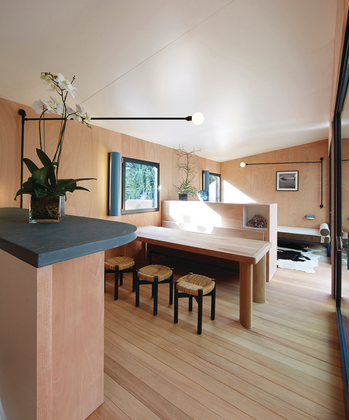 Two black wall sconce lights in natural wood studio room