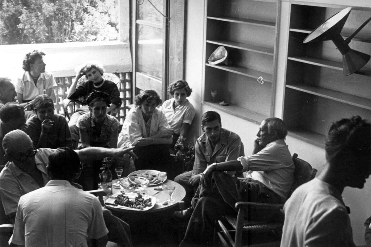 Black and white group shot of artists and designers in a cafe