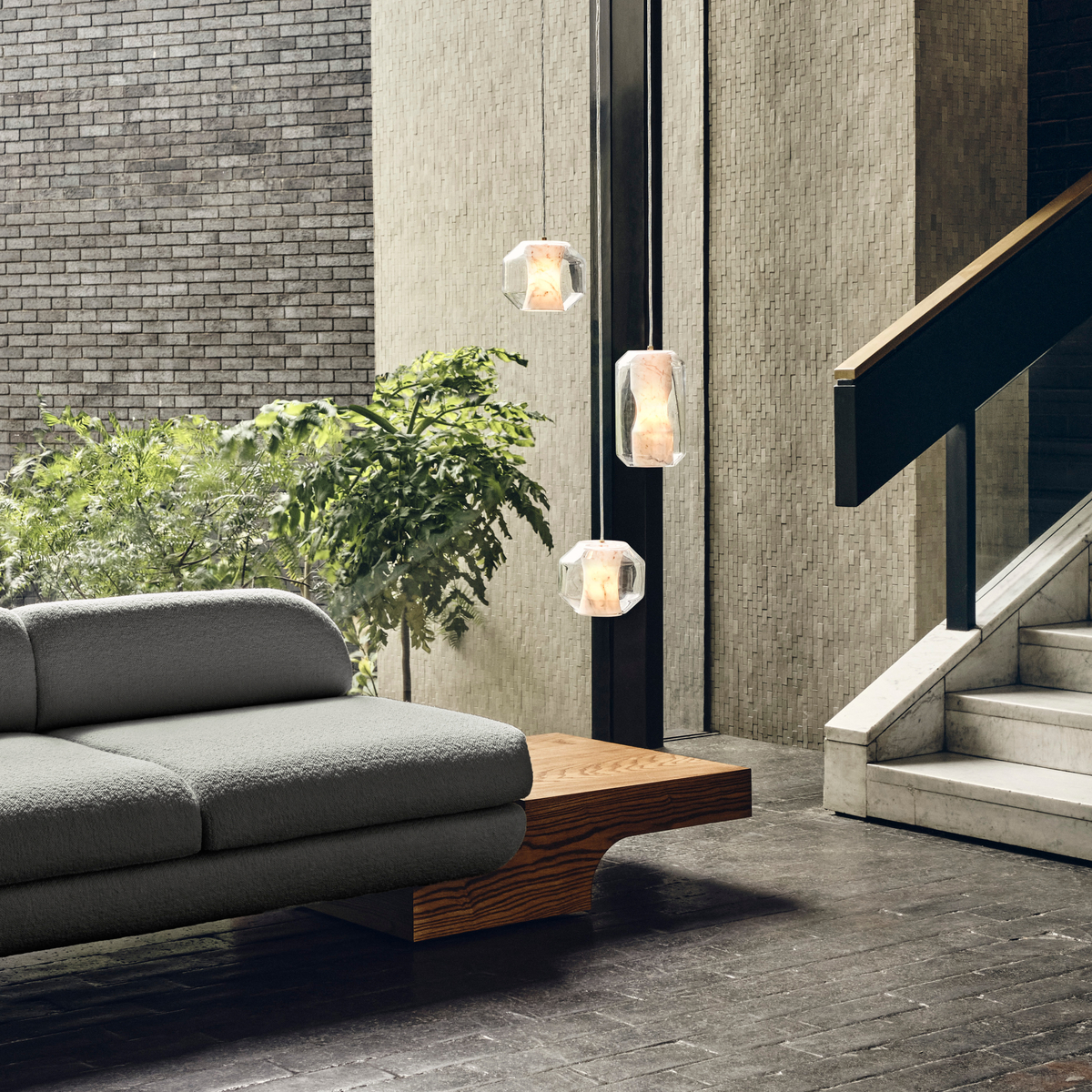 Three crystal lights in gray living room with concrete stairs