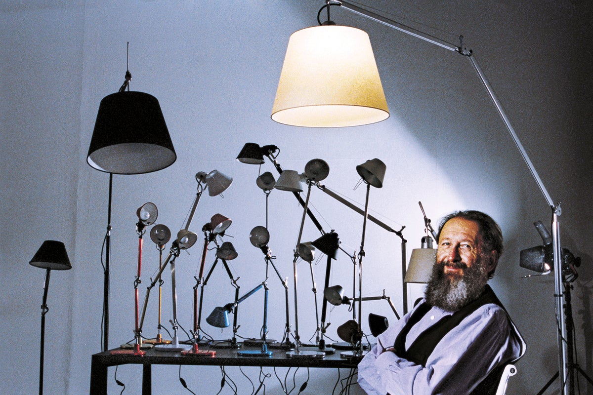 Michele De Lucchi with two lamps.