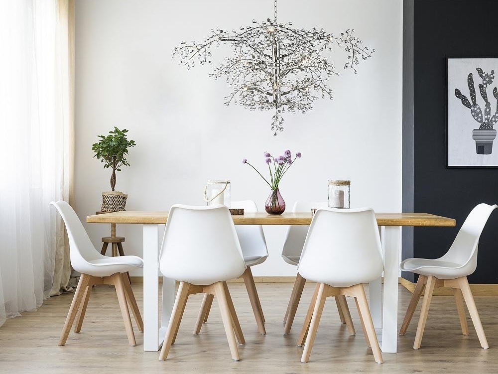 A nature-inspired chandelier over a dining room table.
