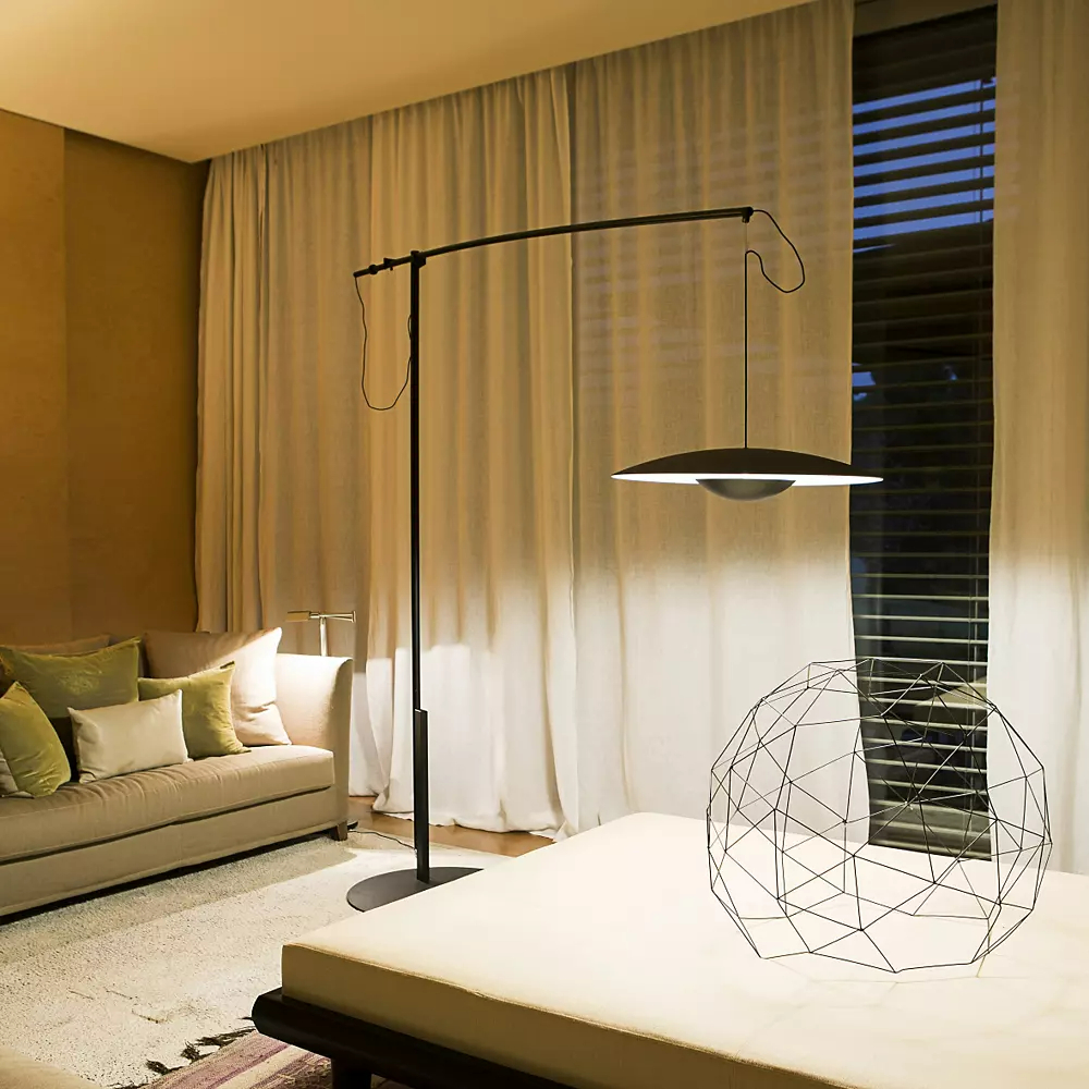 Black floor lamp with geometric decor accent in neutral living room
