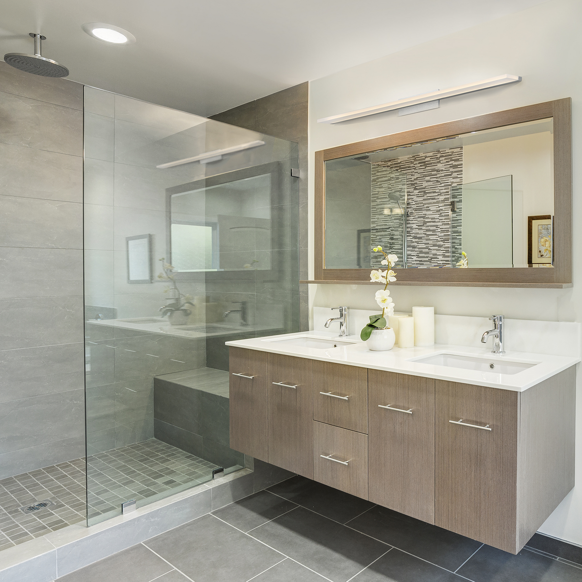 A vanity and shower in a modern bathroom.