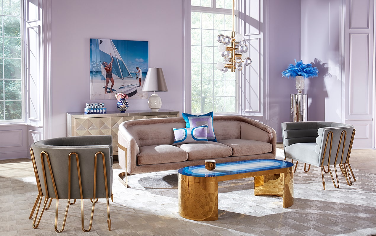 Modern maximalist furniture in purple living room with gold accents