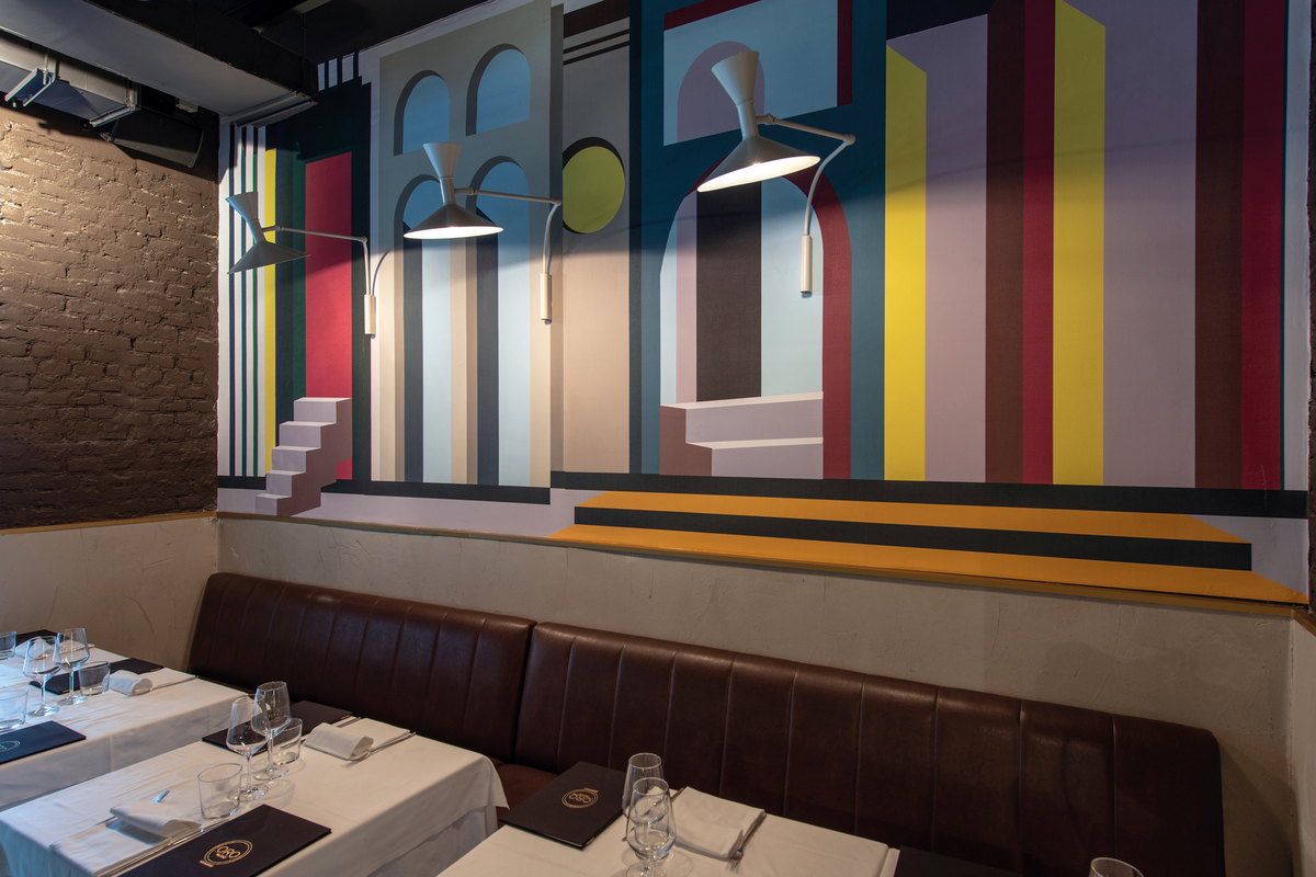 Grey wall sconces on multi-colored wall in restaurant setting