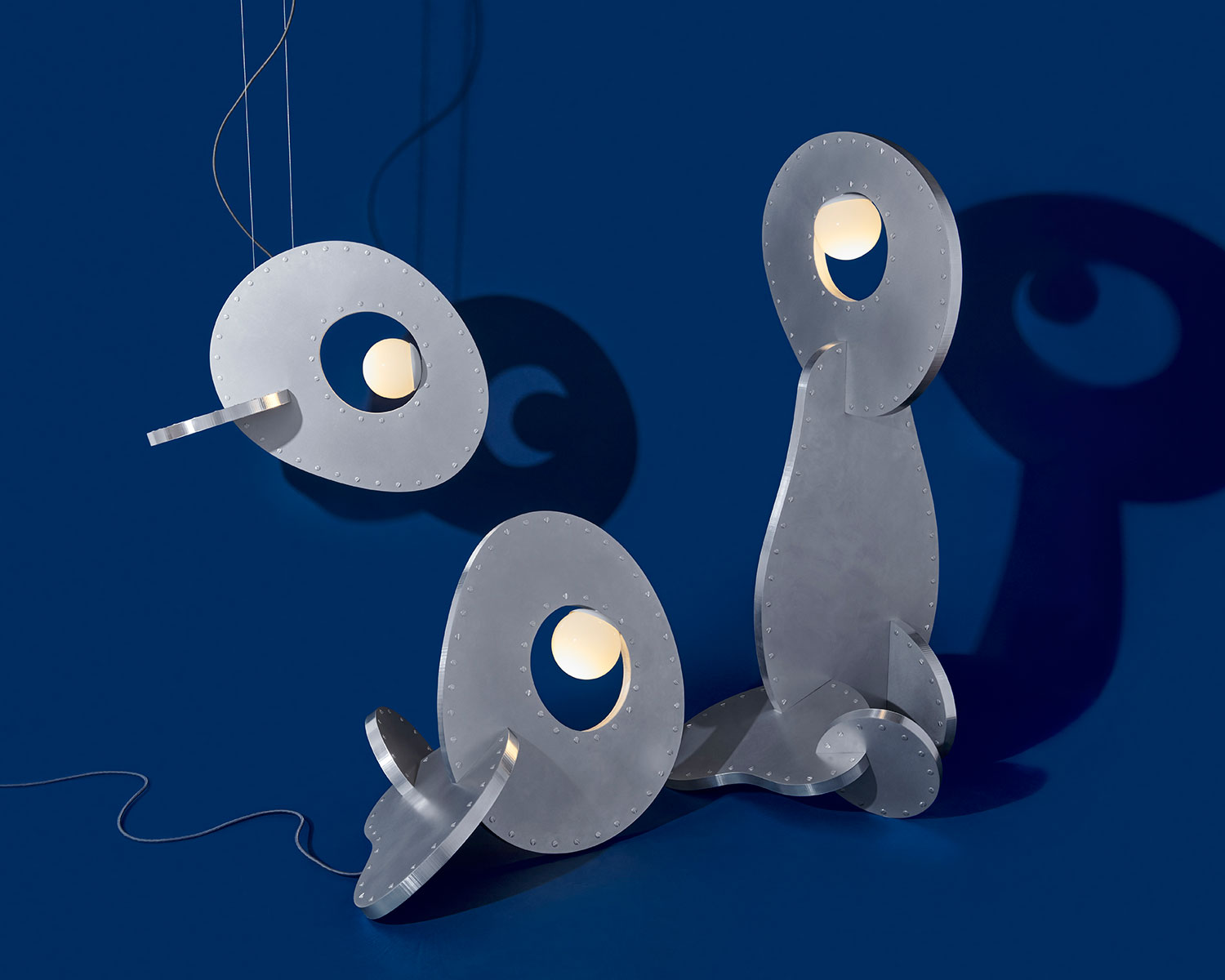 Round metal lamps on a navy blue background