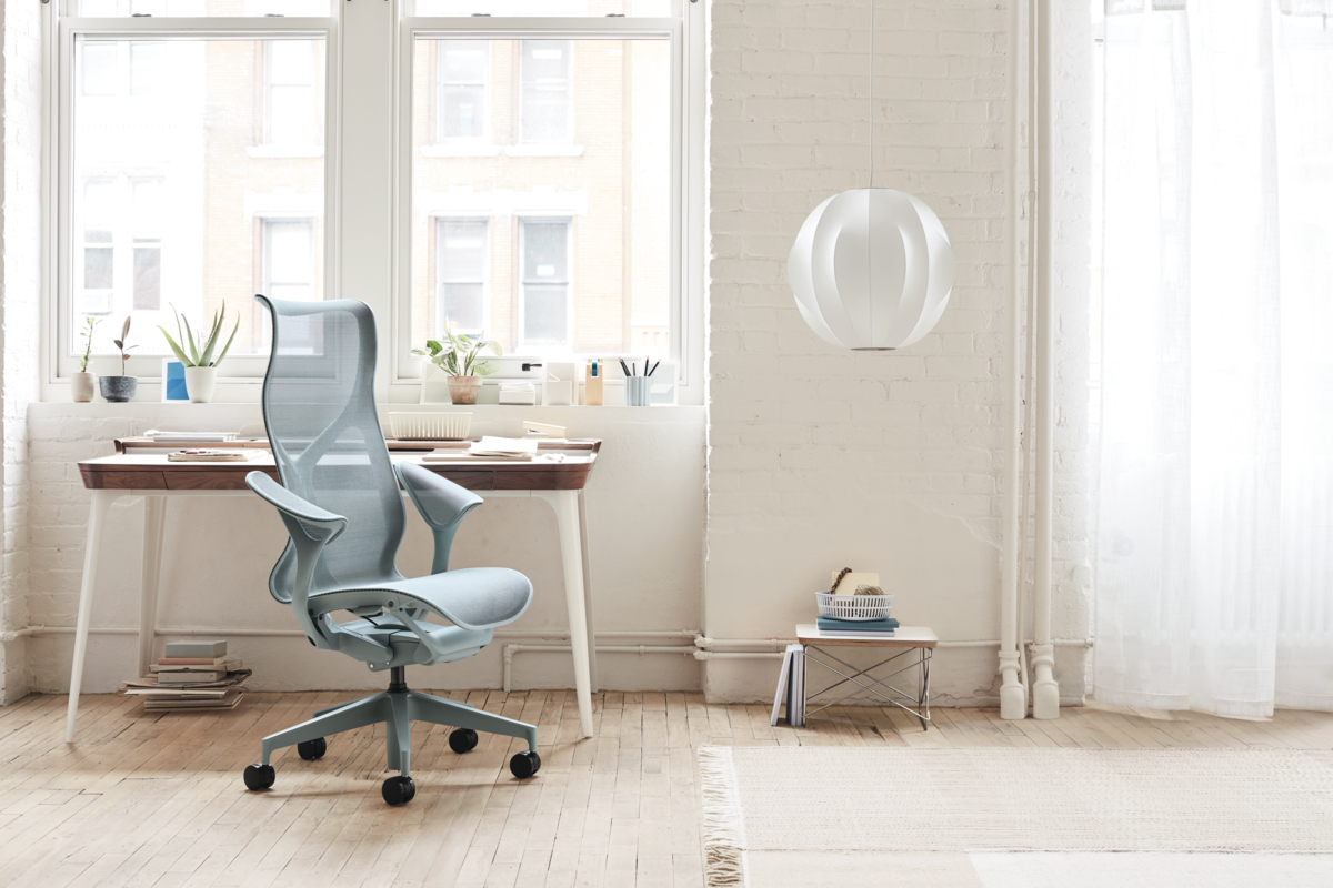 Gray high-back office chair in white modern office space with white pendant light