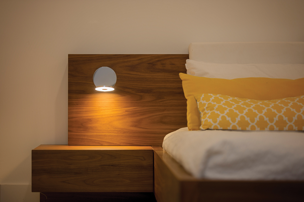 Gravy LED Wall Sconce mounted bedside.