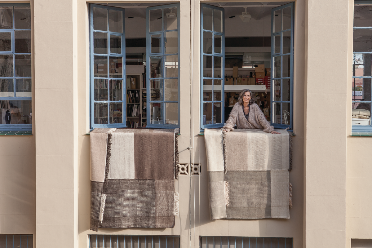 Nani Marquina with her Tres Area Rug in Chocolate and Pearl.