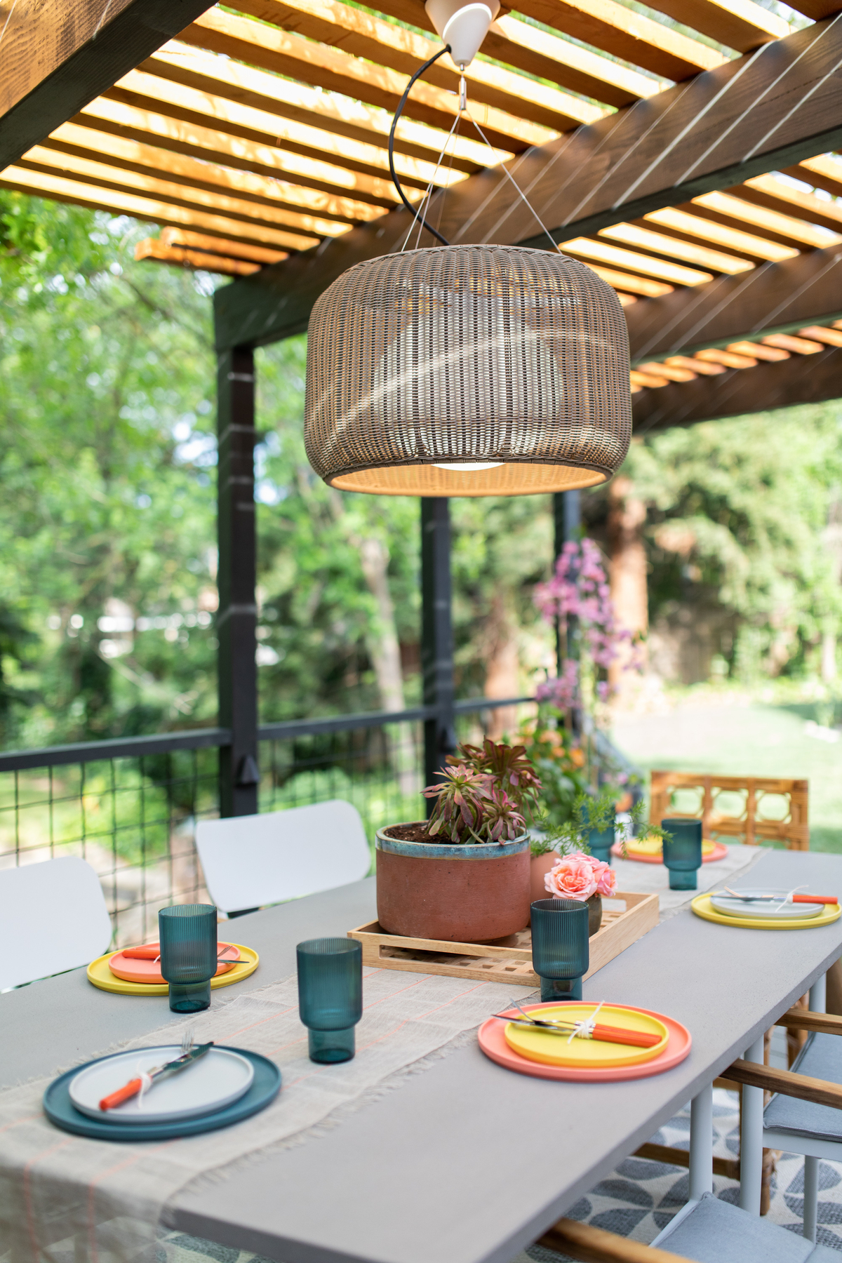 Modern pendant over outdoor dining table.