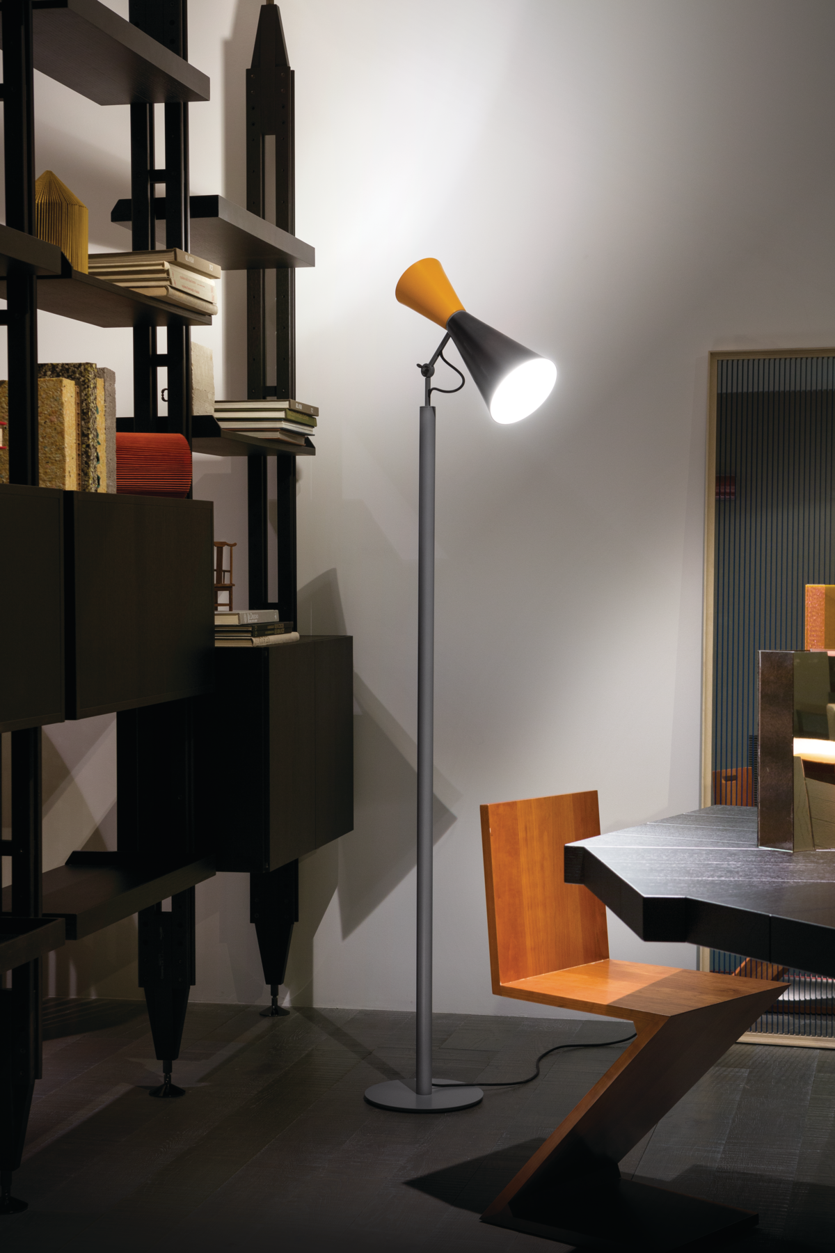 Black, yellow and gray thin lamp in reading nook