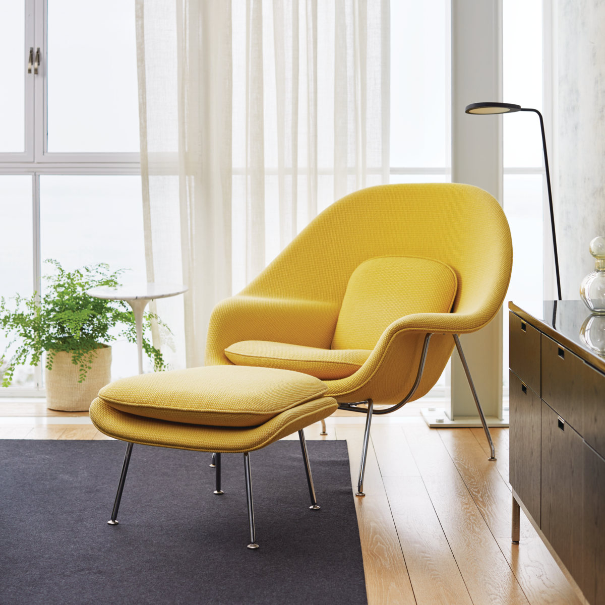 A cozy chair in the corner of a room.