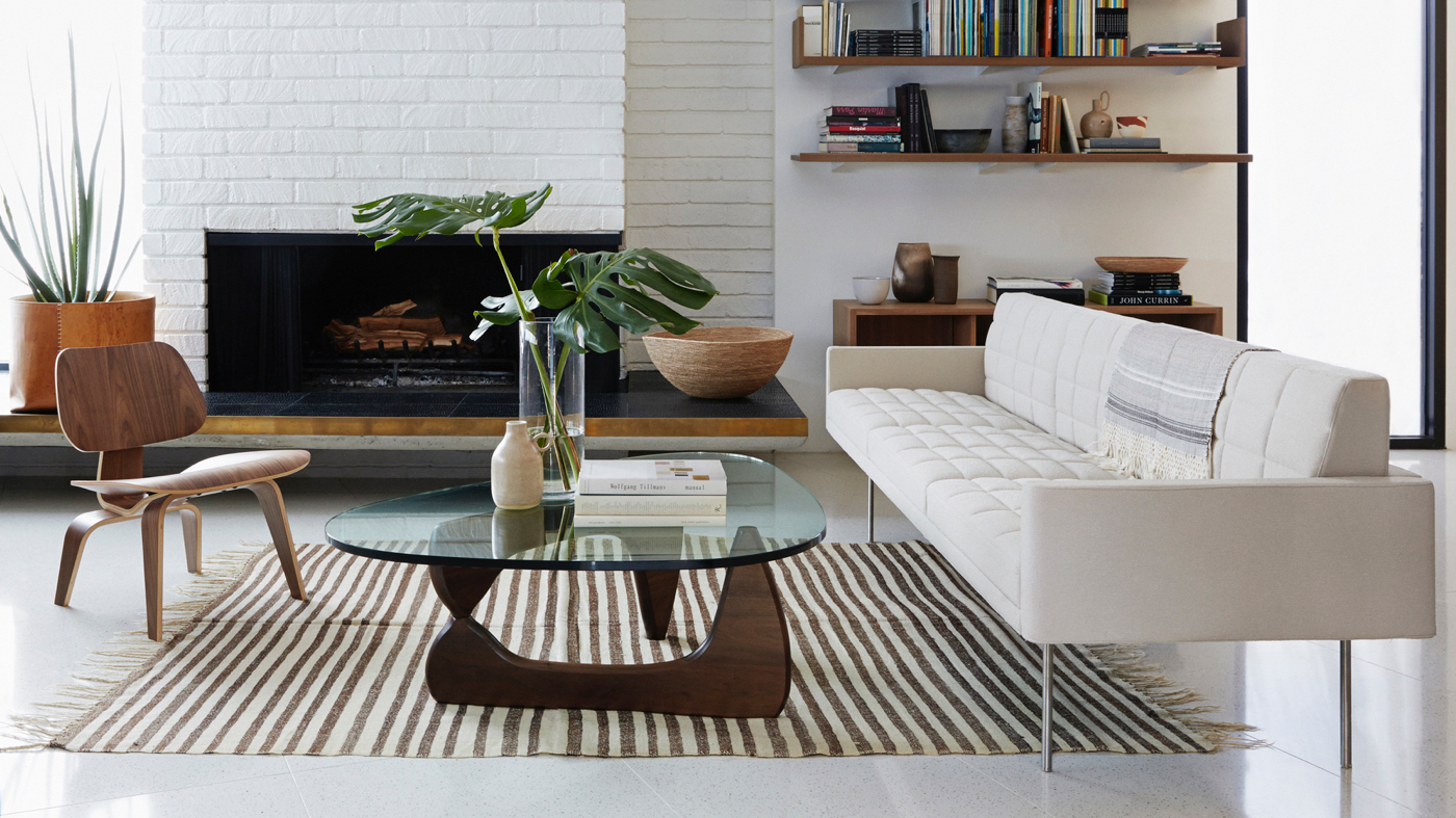 A sofa and coffee table in front of fireplace.