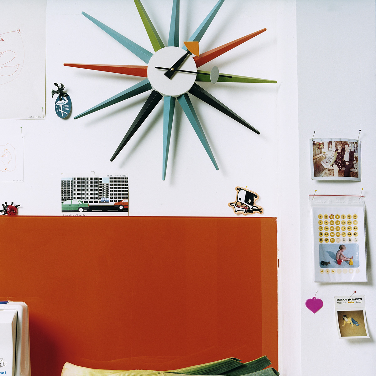 Clock hanging on wall above workspace