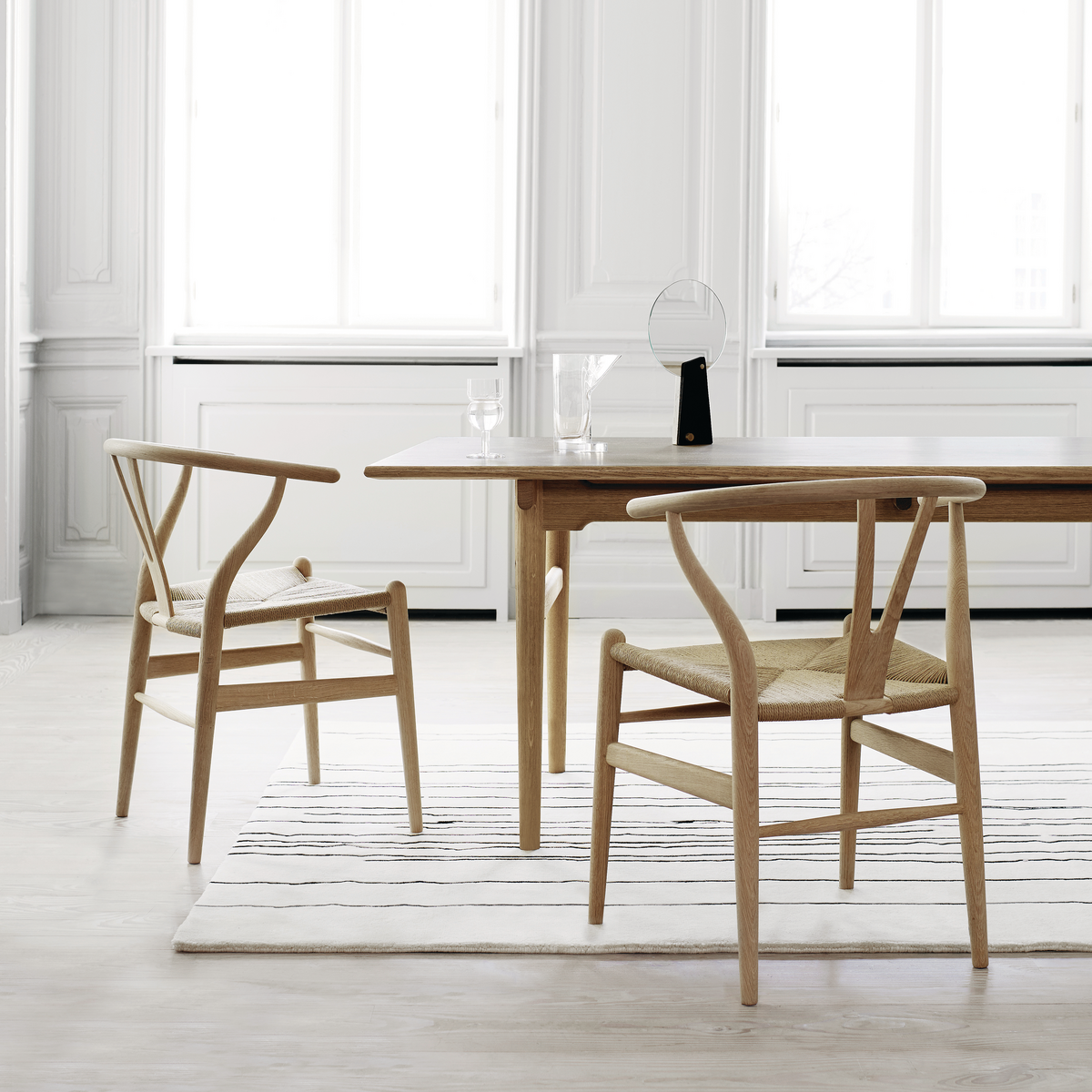 Simple and clean dining area with rug.