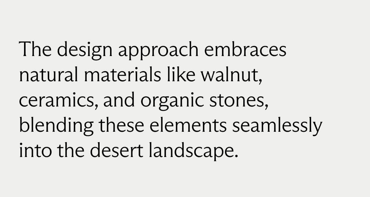The design approach embraces natural materials like walnut, ceramics, and organic stones, blending these elements seamlessly into the desert landscape.