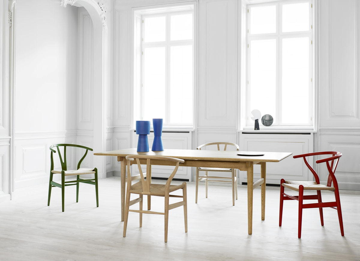 A clean dining space with colorful chairs.