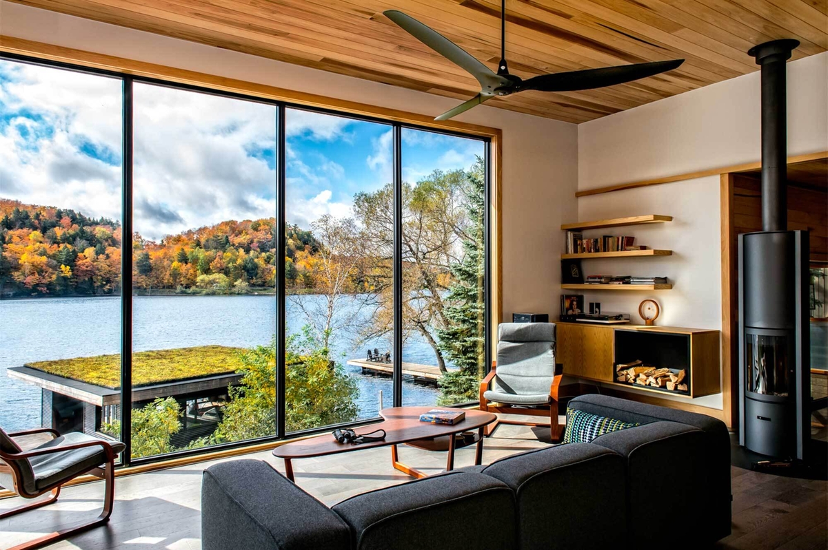 A ceiling fan, a sitting area, and a lake view.
